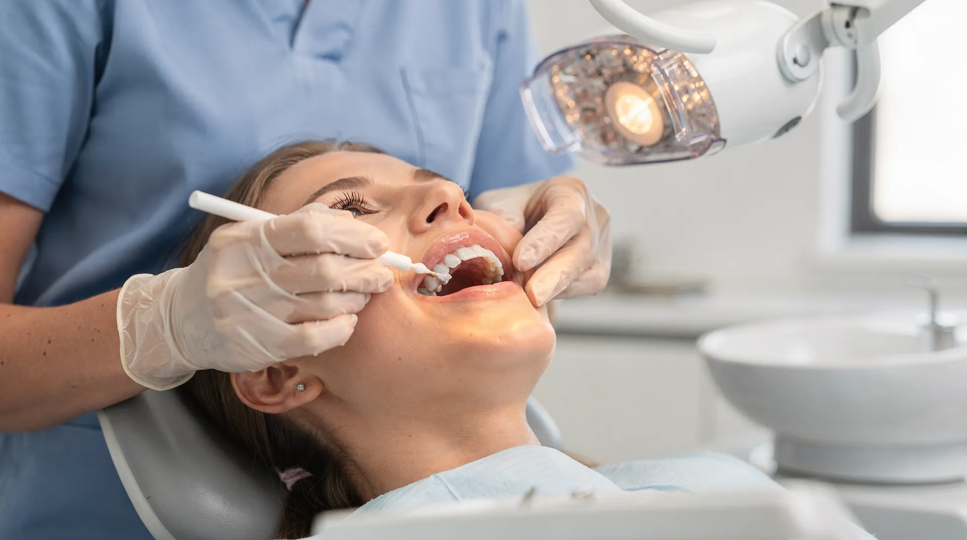 In-office teeth whitening is performed by trained dental professionals, providing safe and reliable bleaching results